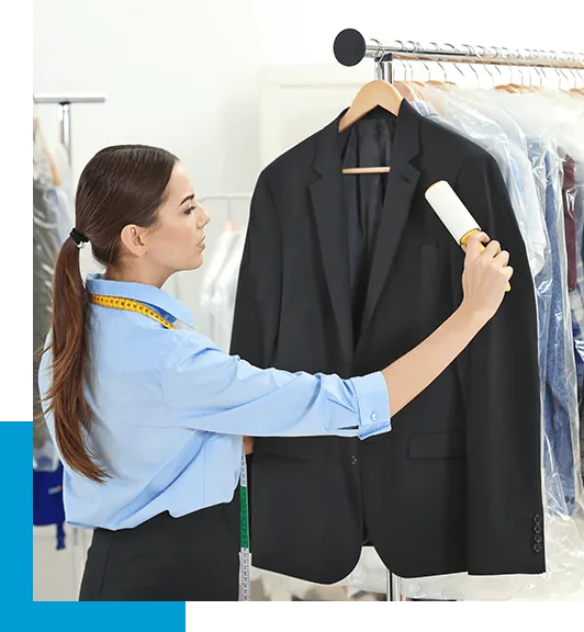 Garment-care worker brushing a suit jacket